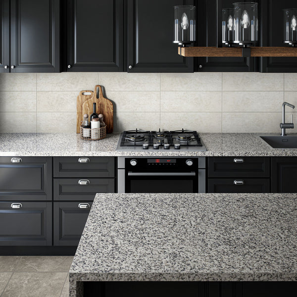 Grey marble kitchen countertop and island, with black cabinets and integrated oven