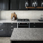 Grey marble kitchen countertop and island, with black cabinets and integrated oven